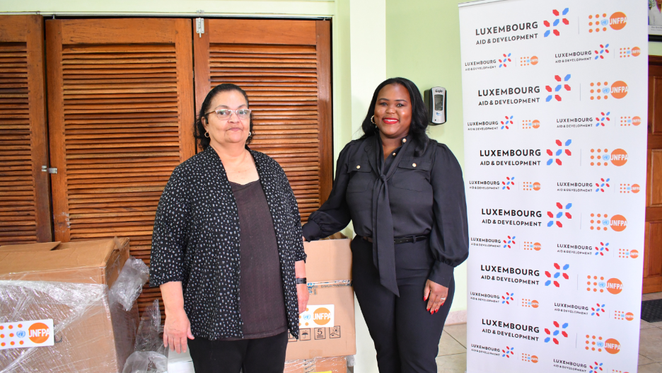 Mackeva Westby-Neal, Programme Officer, UNFPA, Hanning over srh supplies to Dr. Beer, Maternal and Child Health Technical Advisor, Ministry of Health and wellness