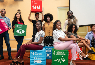 Participants holding boxes labelled with sustainable development goals