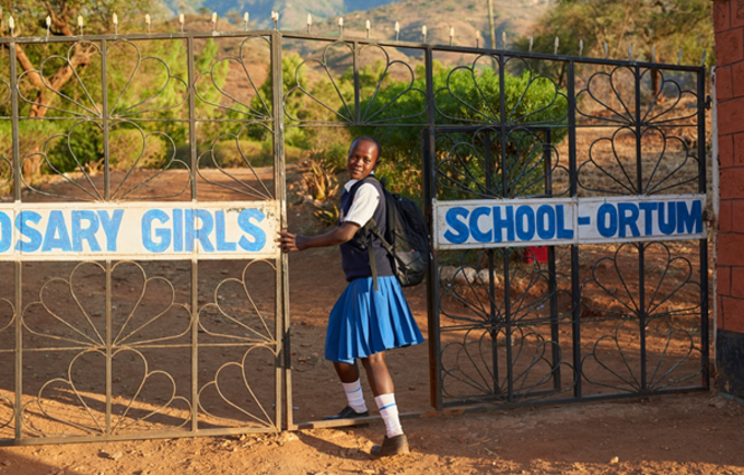 Sharleen, aged 17, enters the school where she continues her studies in Kenya. Her teachers supported her to resist mutilation and early marriage. “My family wanted me to be cut and get married, but I refused,” she said.  “I have stayed firm in pursuing my education.” Photo by Luca Zordan for UNFPA.