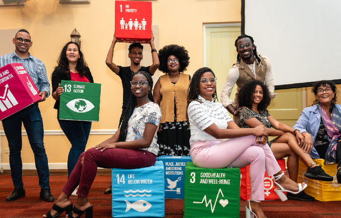 Participants holding boxes labelled with sustainable development goals