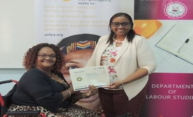 Photo of Charlene Ford being presented with a certificate by Michele Dunn, Programme Assistant in the UNFPA Trinidad Office