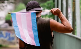 Person holding transgender flag