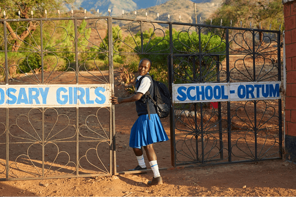 Sharleen, aged 17, enters the school where she continues her studies in Kenya. Her teachers supported her to resist mutilation and early marriage. “My family wanted me to be cut and get married, but I refused,” she said.  “I have stayed firm in pursuing my education.” Photo by Luca Zordan for UNFPA.