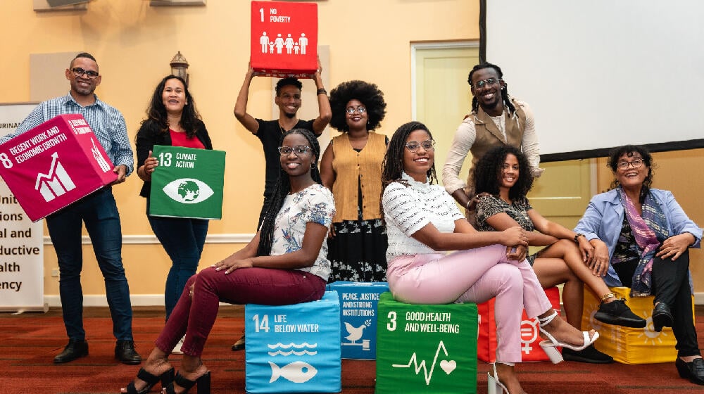 Participants holding boxes labelled with sustainable development goals